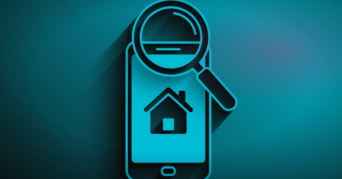 Magnifying glass over a smartphone showing a house icon