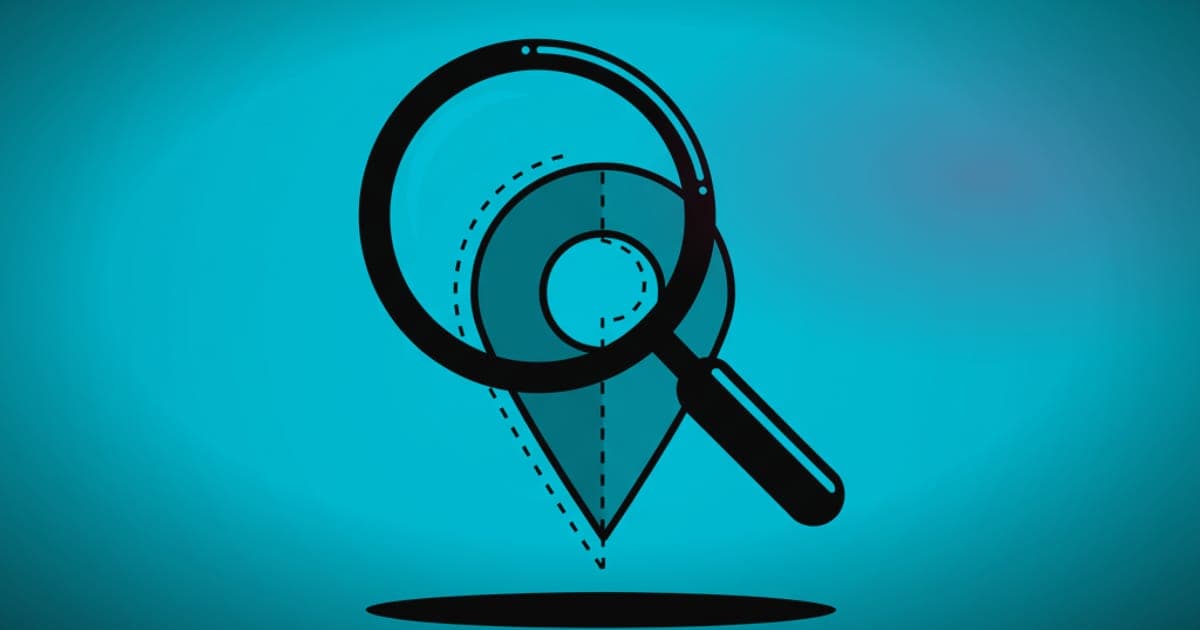 A magnifying glass positioned over a dimmed location pin icon